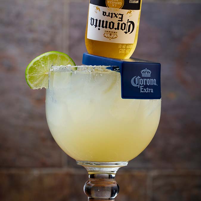 A margarita glass with a lime, an upside-down Corona Extra, perfect for tacos in Escondido.