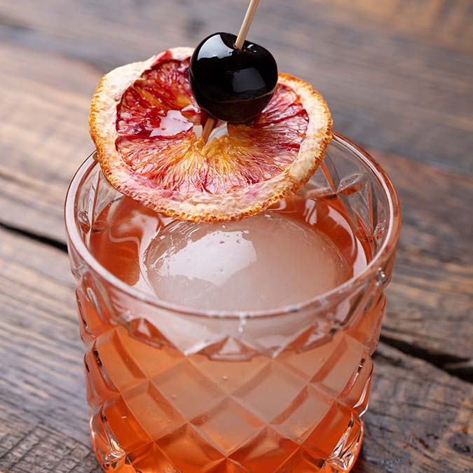 Cocktail with a large ice sphere, perfect for sipping at a lively Mexican restaurant in Escondido.