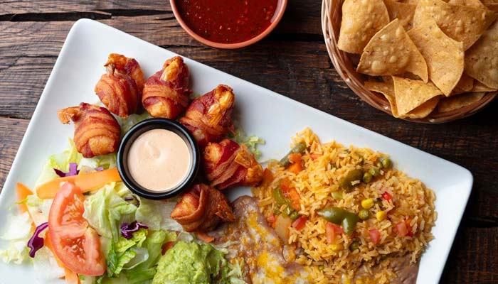 Plate with rice, salad, beans, chips, and salsa—classic Mexican food in Escondido style.
