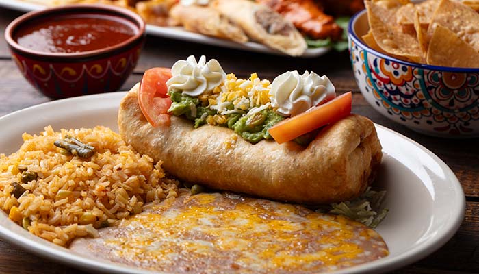 Chimichanga with guac, rice, beans, and chips at Mi Guadalajara Restaurant—authentic Mexican Food!.