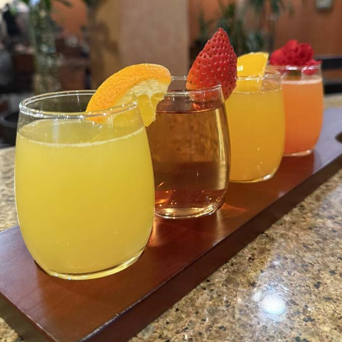 Vibrant drinks at Mi Guadalajara Restaurant, a Mexican restaurant, served fresh on a wooden tray.