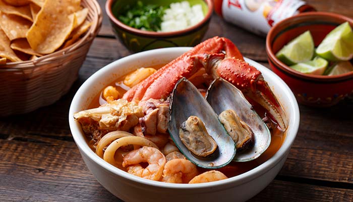 Bowl of seafood soup with crab, mussels, shrimp—Escondido's favorite before tacos or burritos.